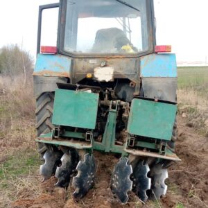 Disking neglected fields with a tractor