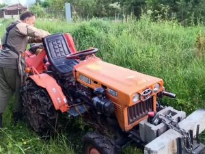 tractor Kubota B7001 with a plow and mulcher to create a firebreak